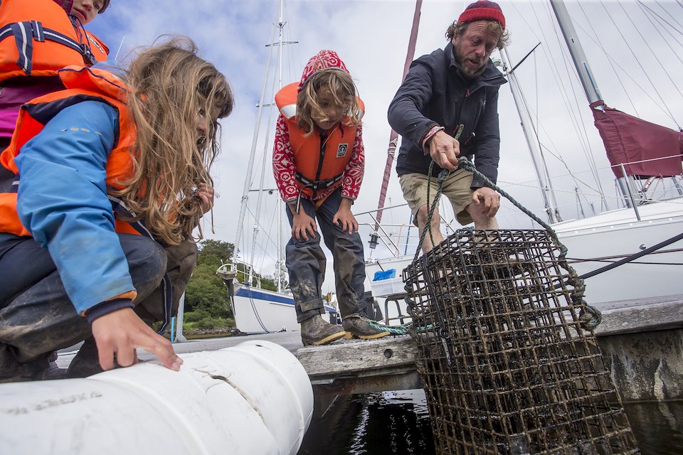 Seawilding Native Oyster Re-introduction. Oyster Hoister project. Sponsored cages put into Ardfern Yacht Centre. The community outreach part of the project. Local Kids, Dan Renton (Head of Seawilding), pulling one of the hoisters out of the water