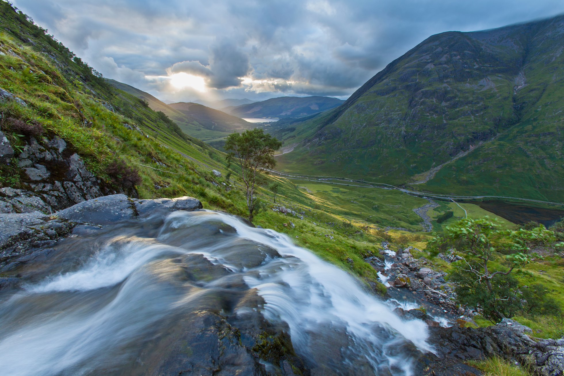 Waterfall above Loch Achtriochtan with Aonach Eagach in background, Glen Coe, Scotland