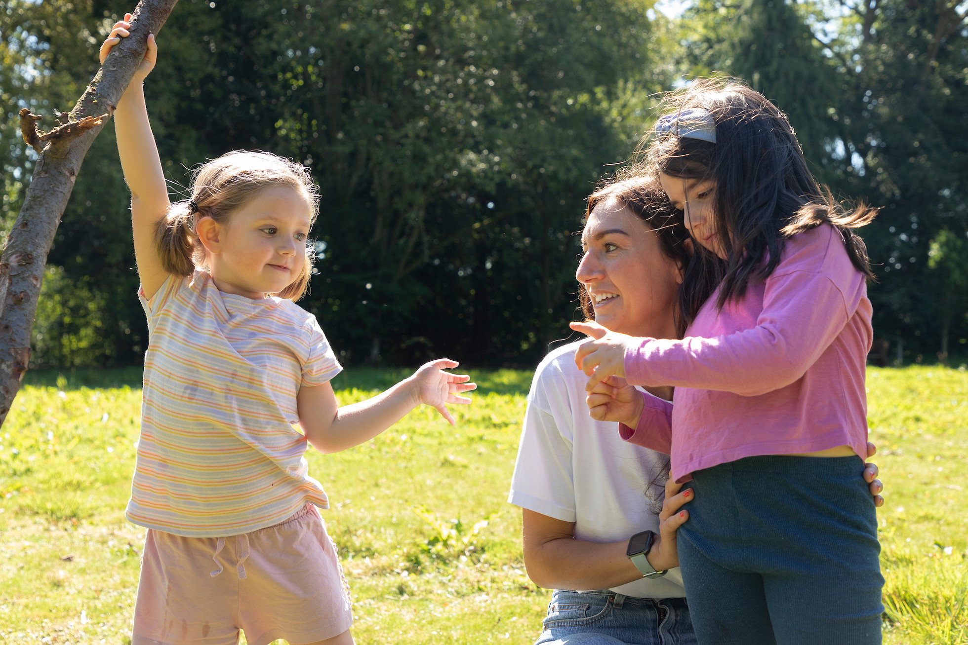 Mother and two young girls in woodland glade, Dunblane